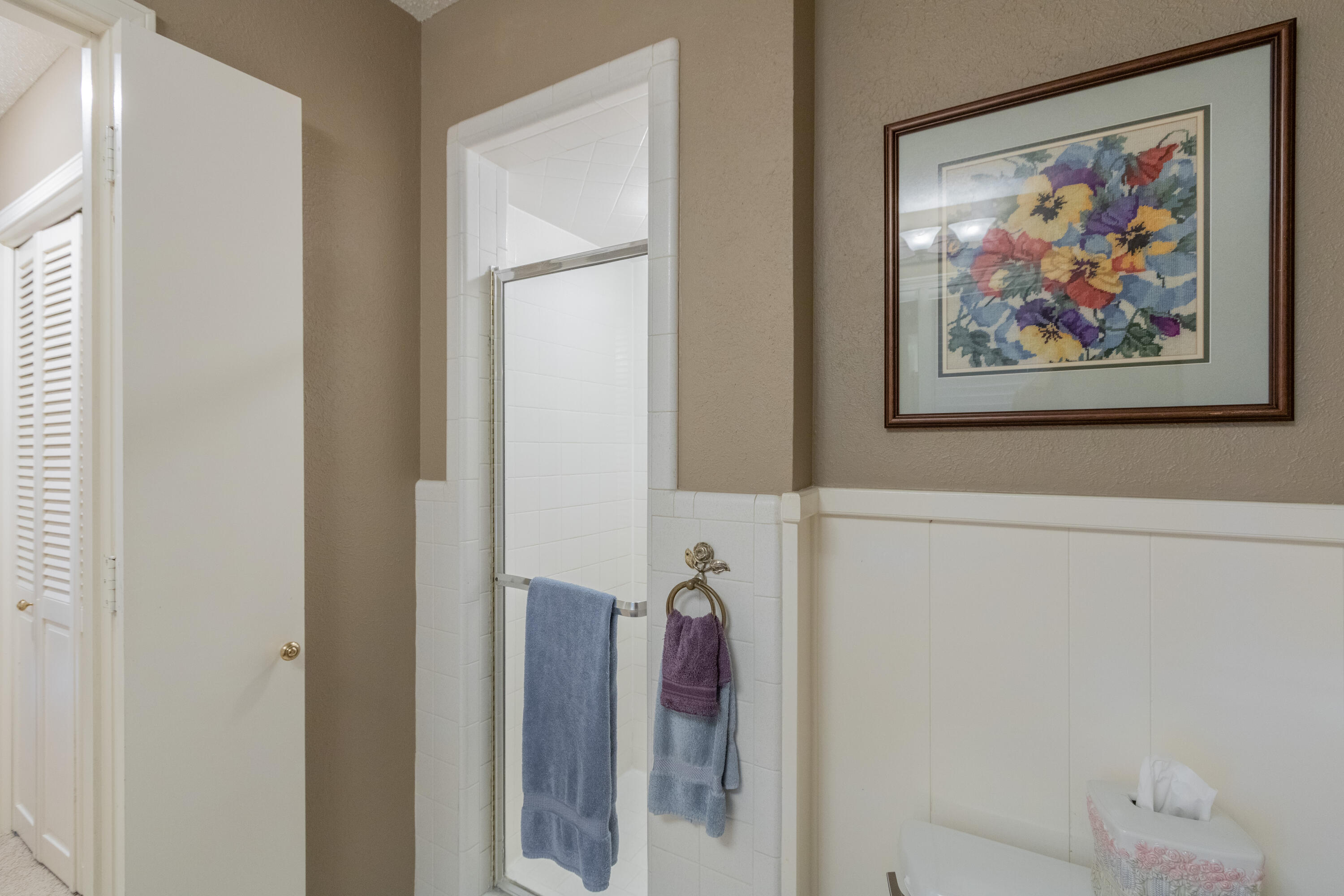 3722 63rd Drive Lubbock, TX 79413 - Photo 35 of 63 a bathroom with a painting on the wall and shower