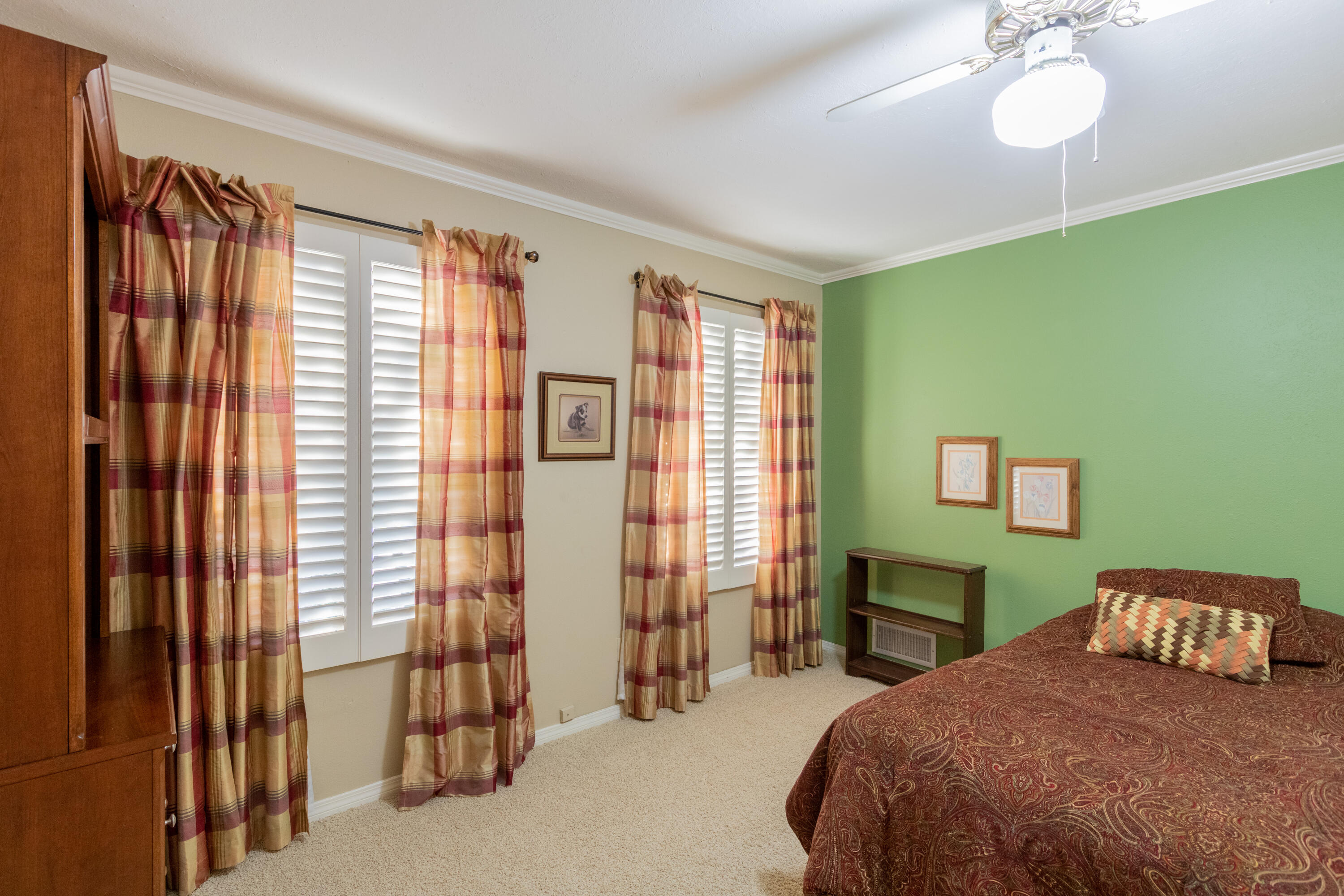 3722 63rd Drive Lubbock, TX 79413 - Photo 40 of 63 a bedroom with a bed and a chandelier