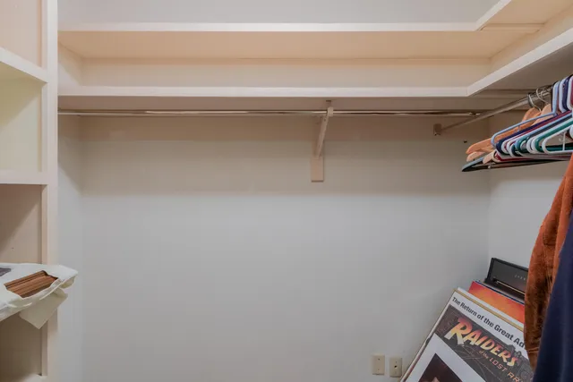 a view of backyard with a table and chairs and potted plants