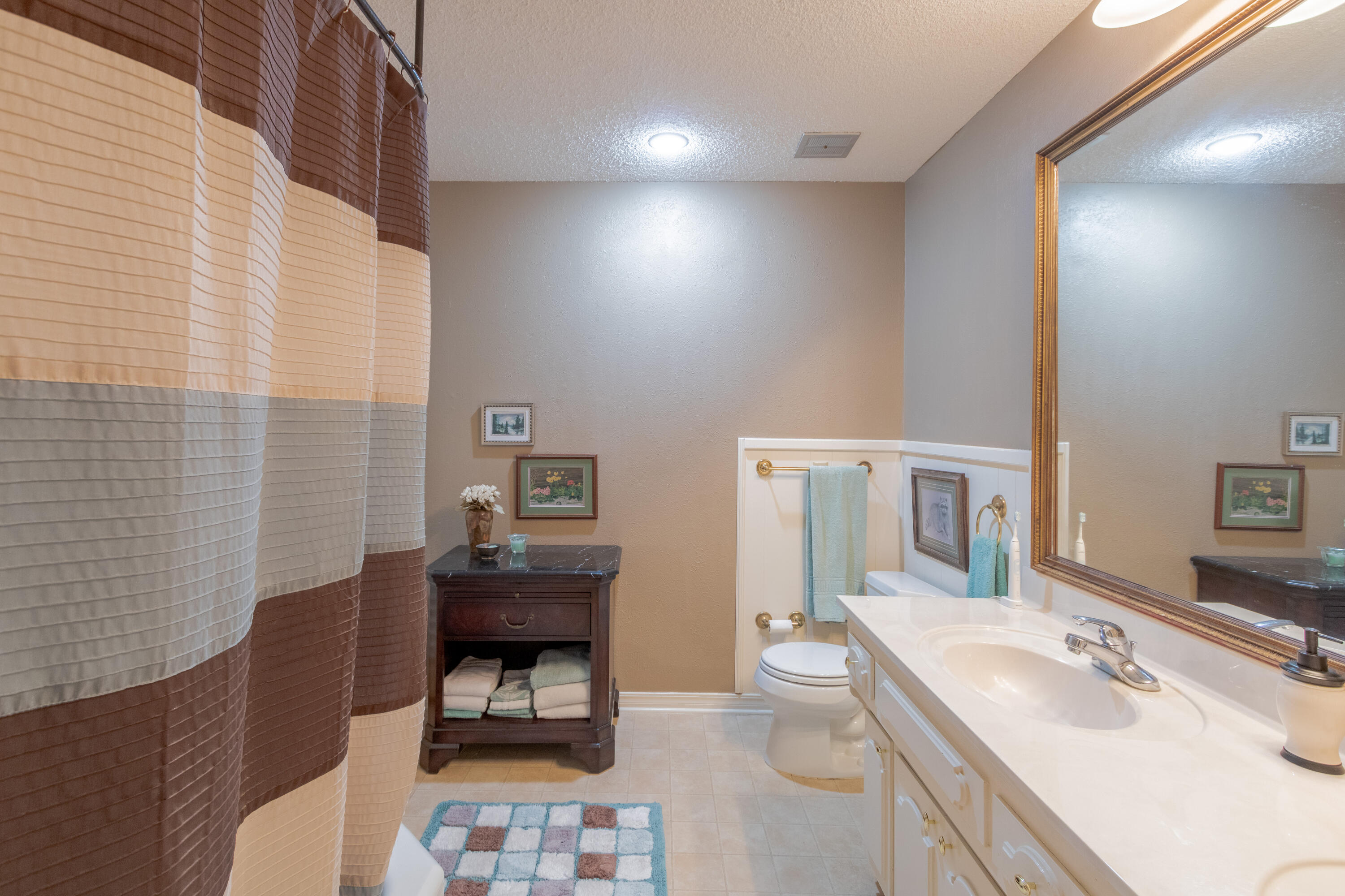 3722 63rd Drive Lubbock, TX 79413 - Photo 46 of 63 a bathroom with a sink double vanity and a tub