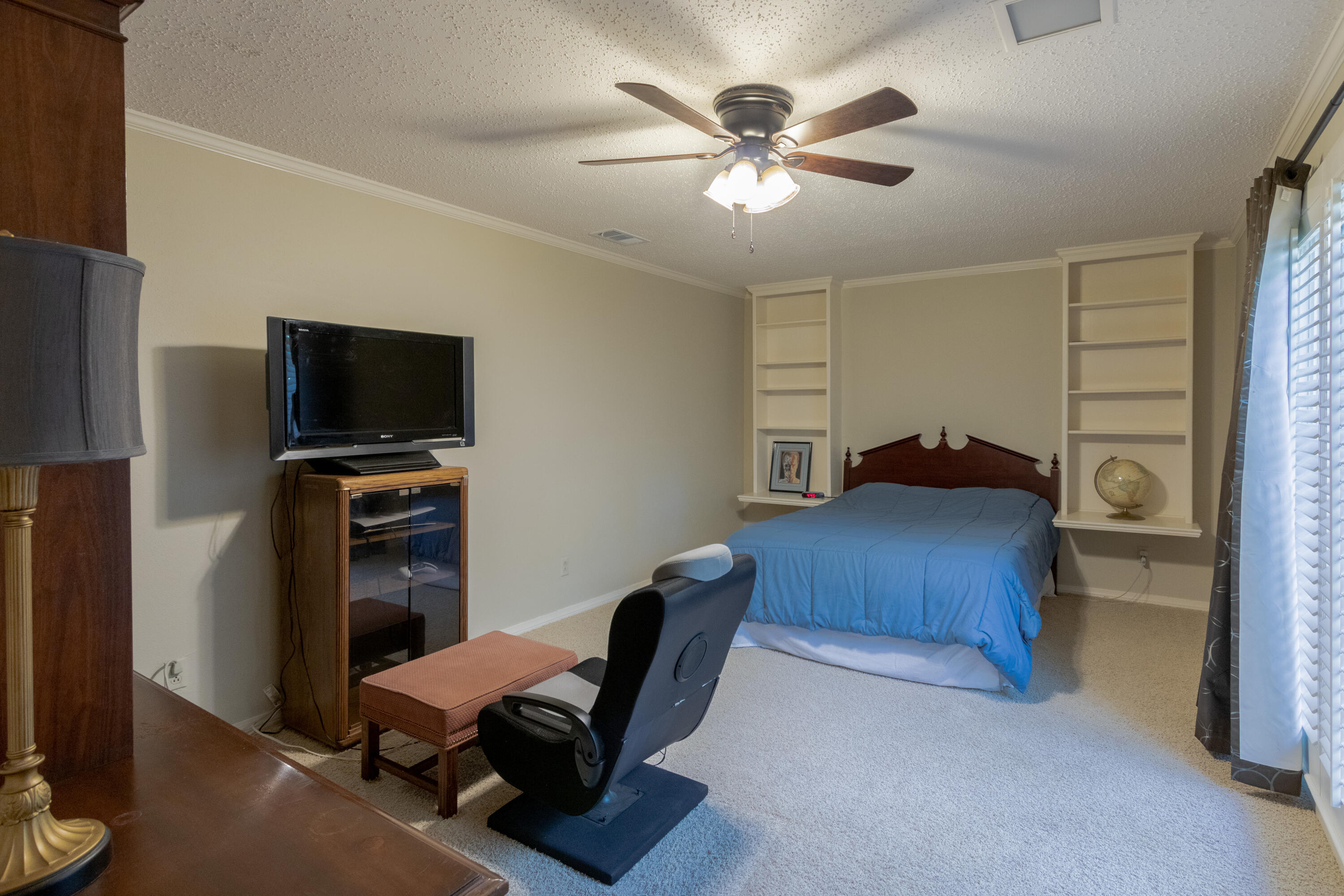 3722 63rd Drive Lubbock, TX 79413 - Photo 50 of 63 a bedroom with a bed and a flat screen tv