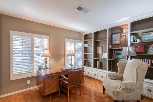 a living room with furniture and a lamp