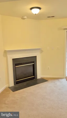 a view of empty room with a fireplace