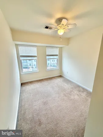 an empty room with windows and chandelier