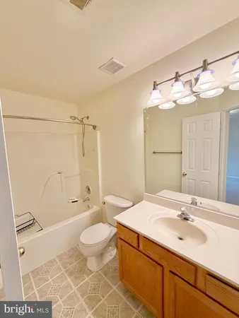 a bathroom with a sink toilet double vanity and shower