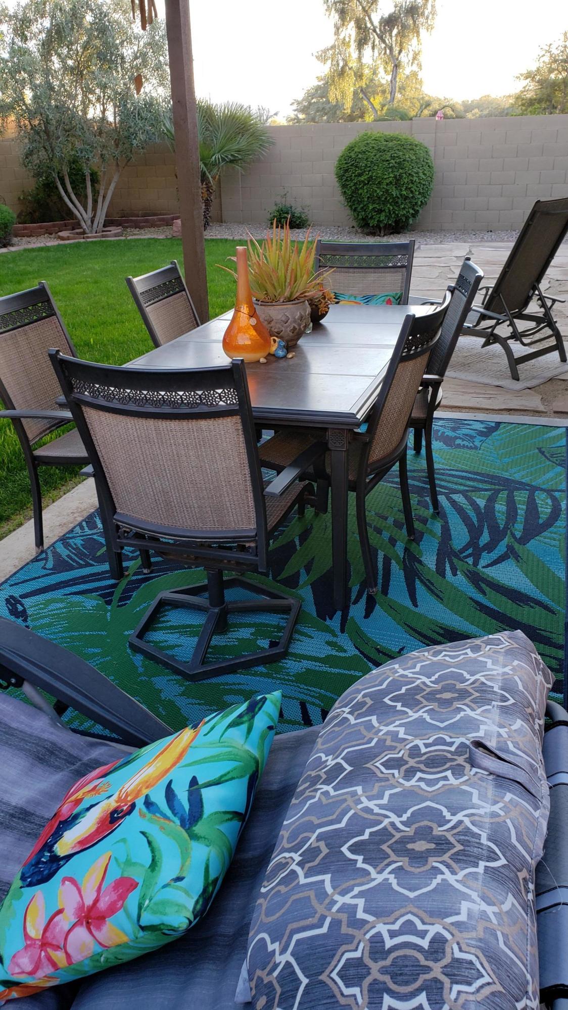 17531 West Boca Raton Road Surprise, AZ 85388 - Photo 19 of 32 a view of a chairs with a table in the patio