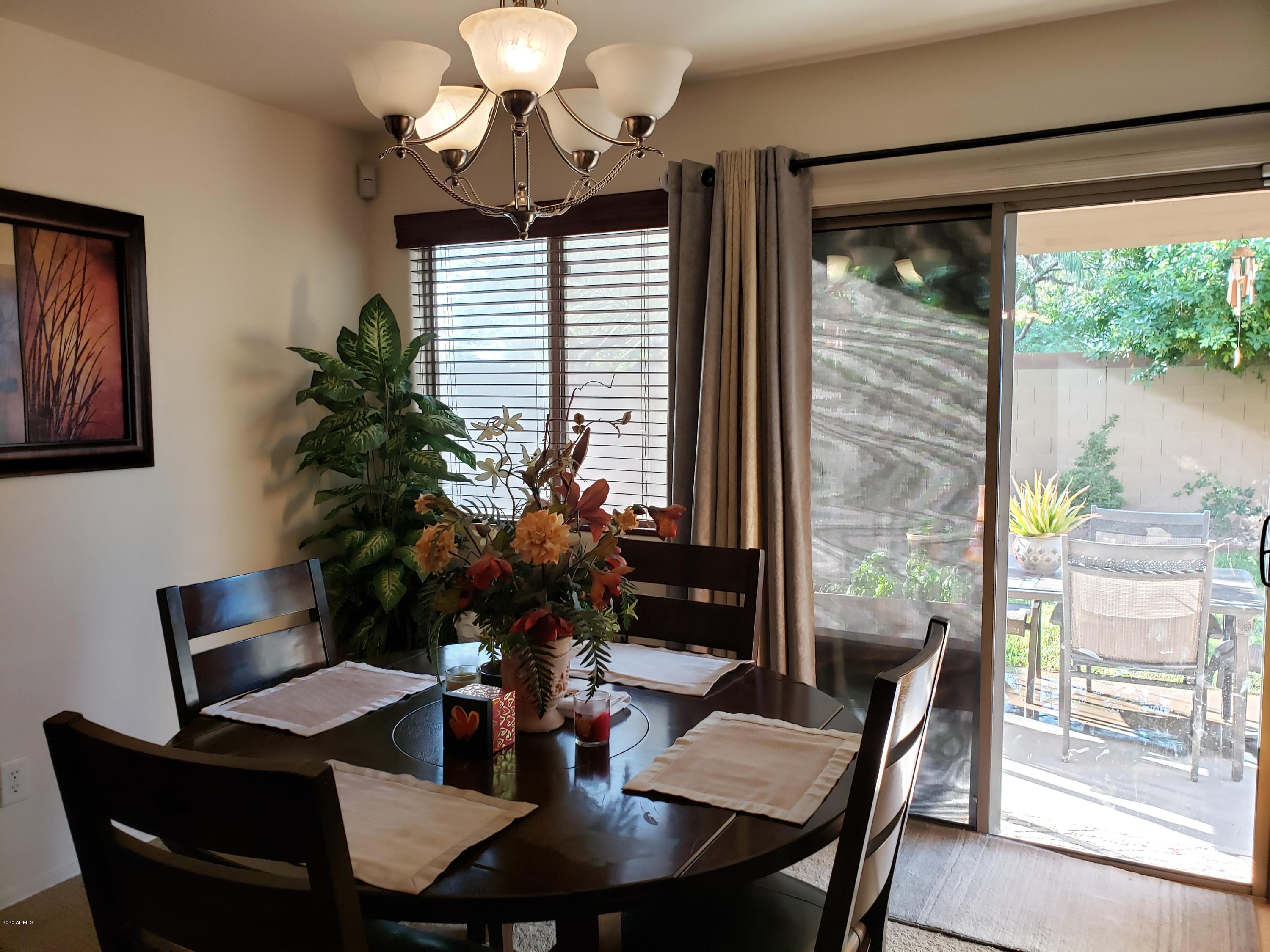 17531 West Boca Raton Road Surprise, AZ 85388 - Photo 6 of 32 a view of a dining room with furniture window and outside view