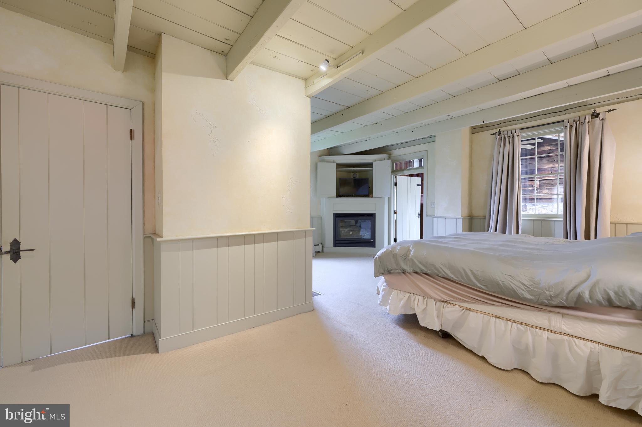 705 Schoffers Road Birdsboro, PA 19508 - Photo 78 of 112 a spacious bedroom with a bed and a couch