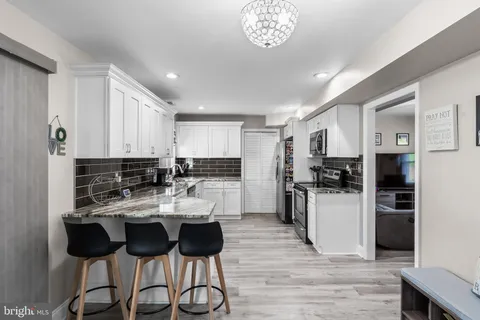a kitchen with a refrigerator and cabinets