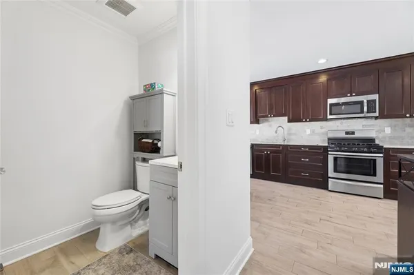 a kitchen with stainless steel appliances a stove and cabinets
