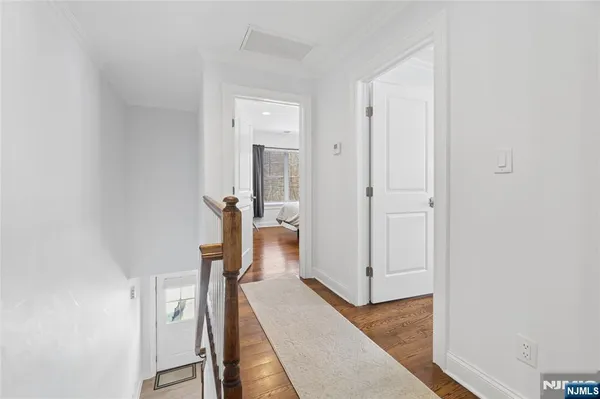 a view of a hallway with a room and stairs
