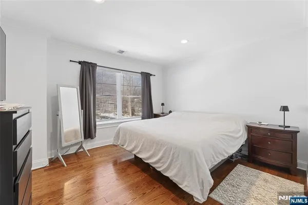 a bedroom with a bed and a large window