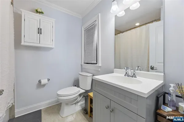a bathroom with a sink toilet and mirror