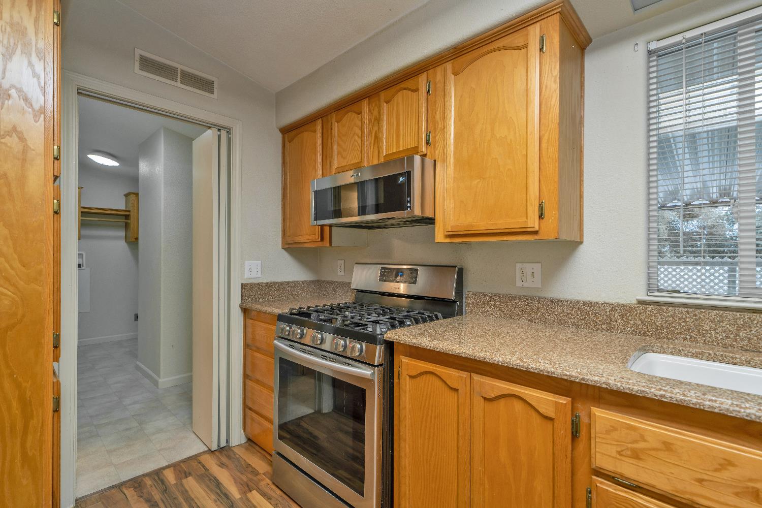 3550 China Garden Road, Unit 102 Placerville, CA 95667 - Photo 13 of 30 a kitchen with stainless steel appliances granite countertop a stove a sink and a microwave