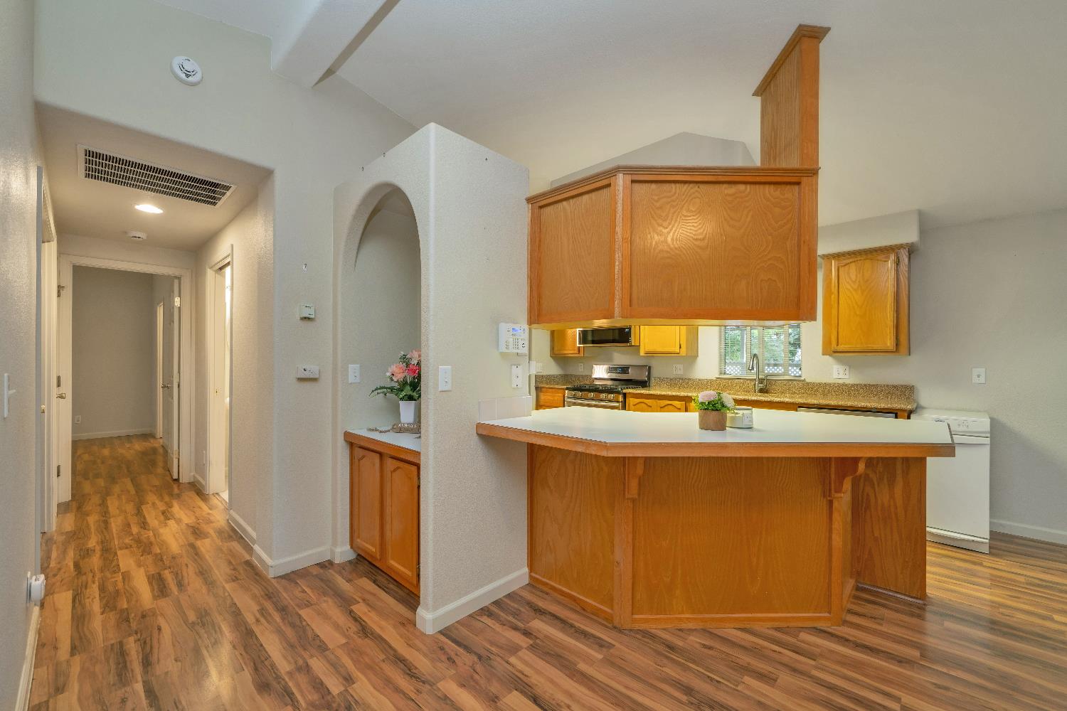 3550 China Garden Road, Unit 102 Placerville, CA 95667 - Photo 14 of 30 a kitchen with kitchen island granite countertop wooden floor and sink