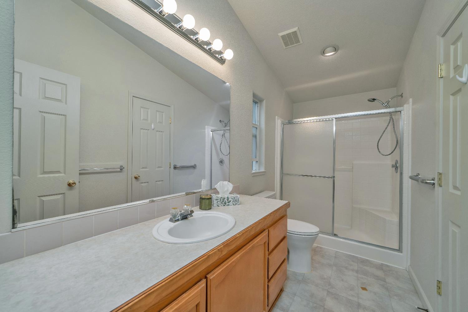 3550 China Garden Road, Unit 102 Placerville, CA 95667 - Photo 19 of 30 a bathroom with a double vanity sink mirror and shower