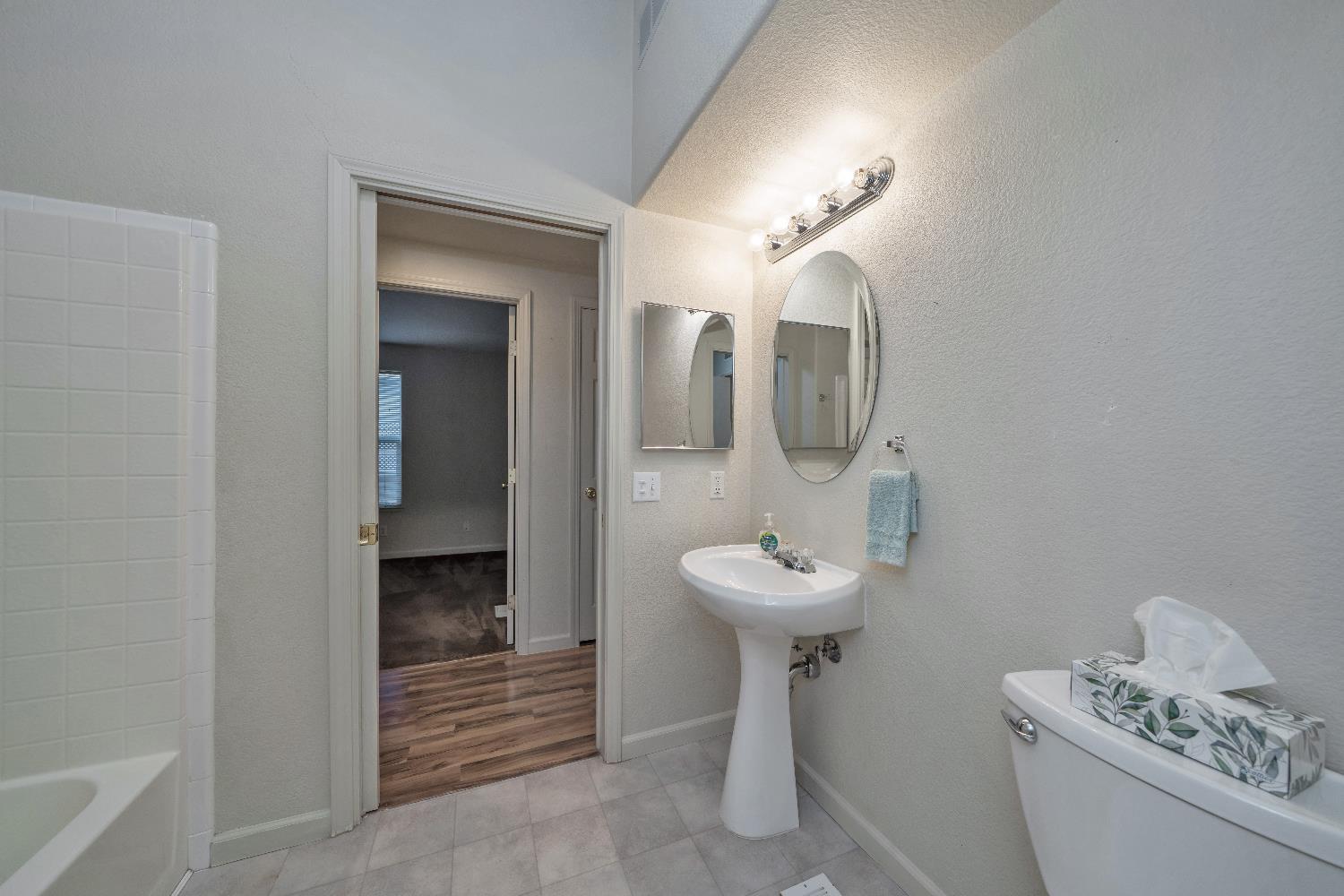 3550 China Garden Road, Unit 102 Placerville, CA 95667 - Photo 23 of 30 a bathroom with a toilet sink and mirror