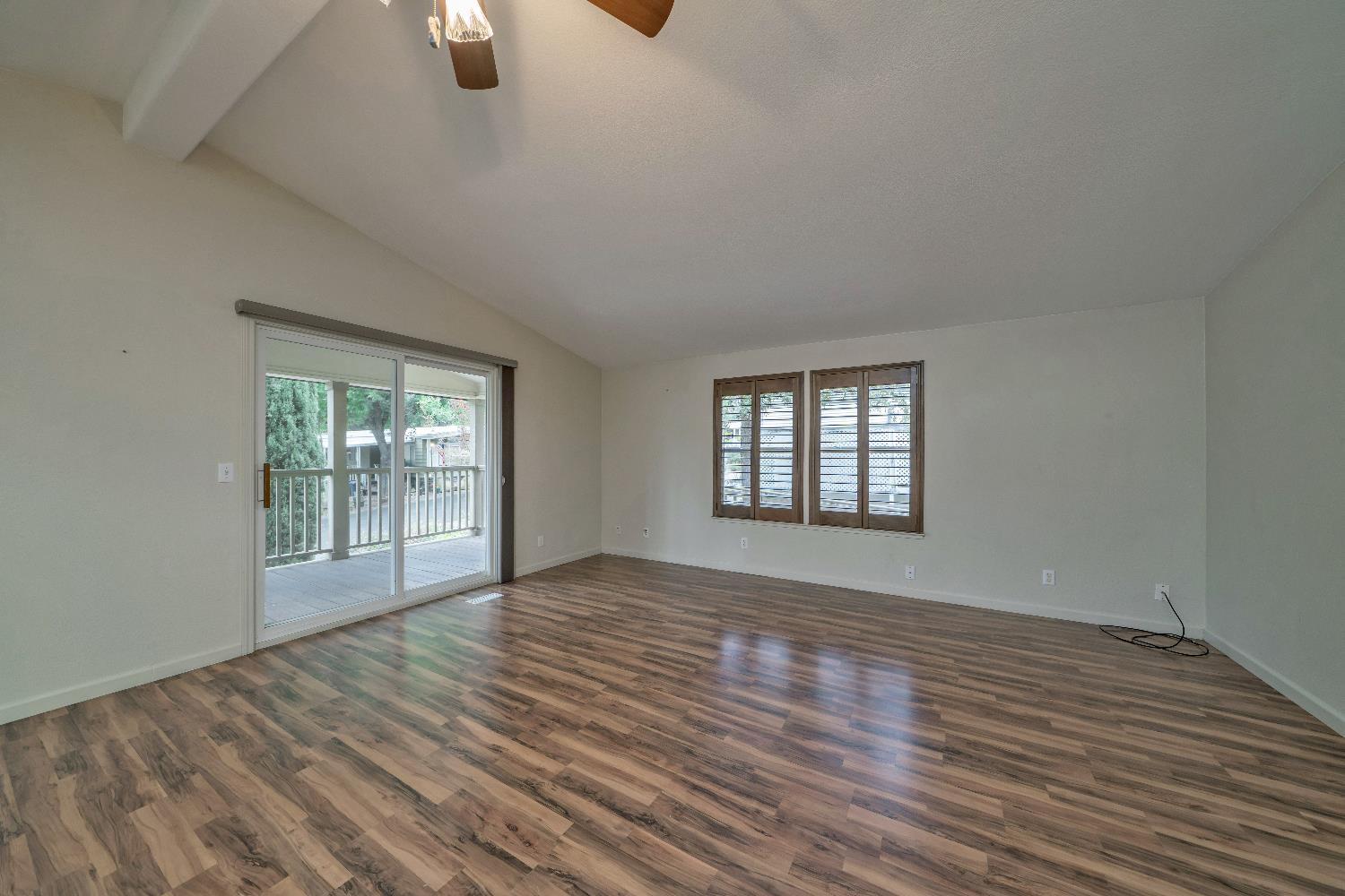 3550 China Garden Road, Unit 102 Placerville, CA 95667 - Photo 6 of 30 a view of an empty room with wooden floor and a window