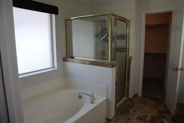 a bathroom with a bathtub and a shower