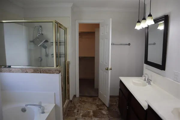 a bathroom with a tub sink and mirror