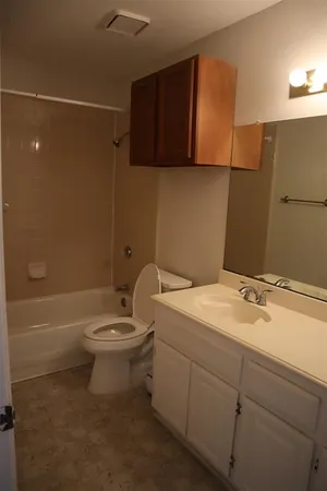 a bathroom with a sink a toilet and bathtub