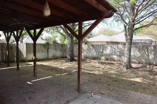 a view of a backyard with large tree