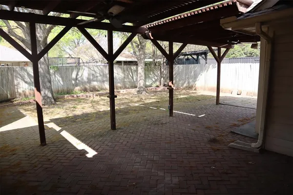 a view of empty room with wooden floor and door