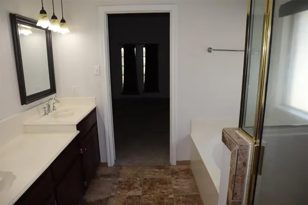 a bathroom with a sink a mirror and a shower