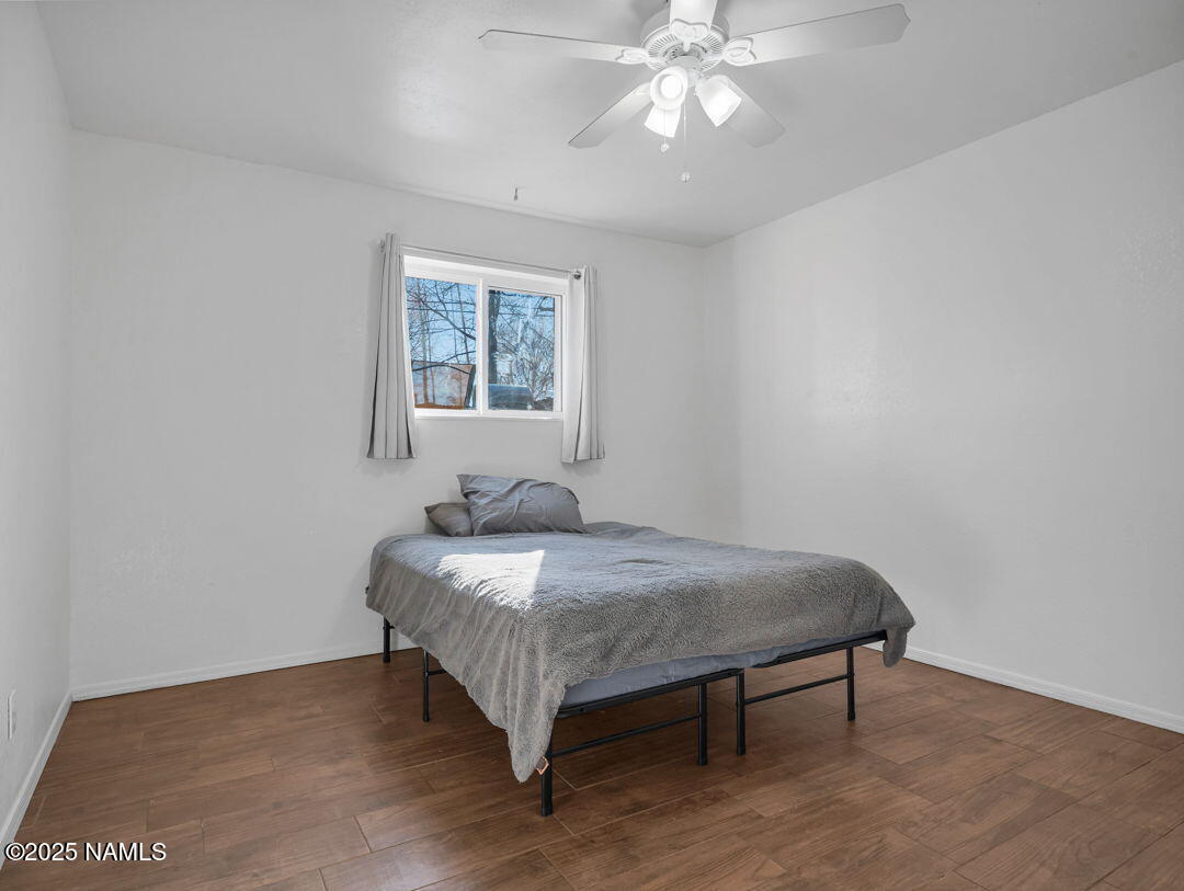 615 West Beal Road Flagstaff, AZ 86001 - Photo 24 of 37 a bedroom with a bed and a chandelier