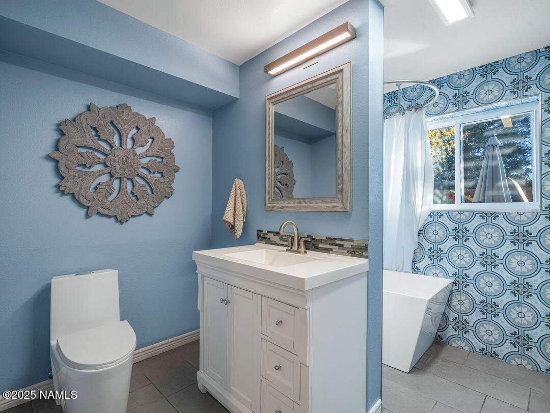 615 West Beal Road Flagstaff, AZ 86001 - Photo 27 of 37 a bathroom with a toilet sink and mirror