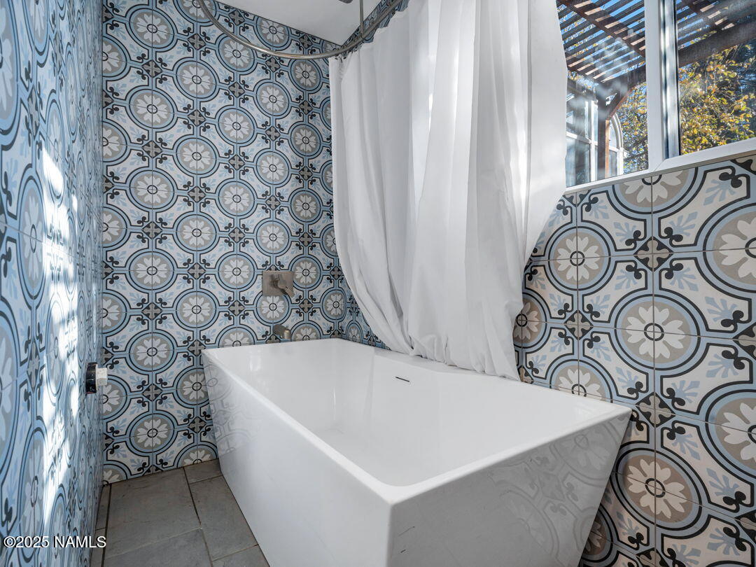 615 West Beal Road Flagstaff, AZ 86001 - Photo 28 of 37 a bathroom with a bathtub and shower curtain
