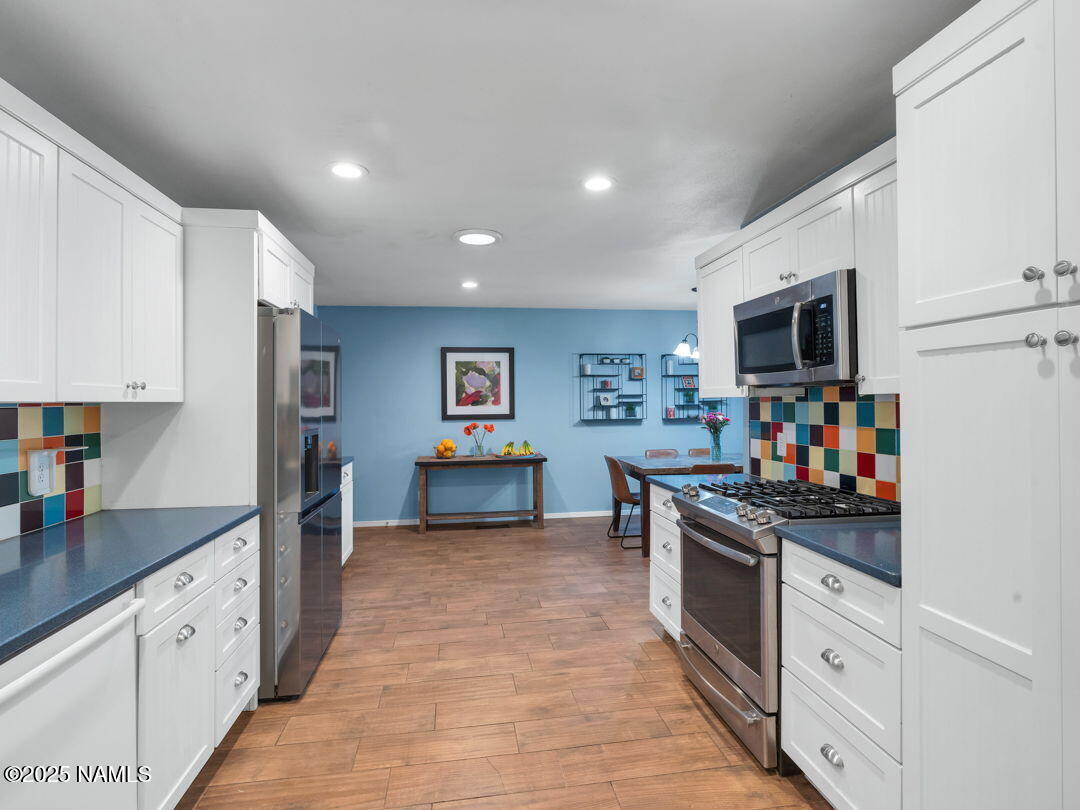 615 West Beal Road Flagstaff, AZ 86001 - Photo 6 of 37 a kitchen with stainless steel appliances granite countertop a refrigerator and a stove top oven