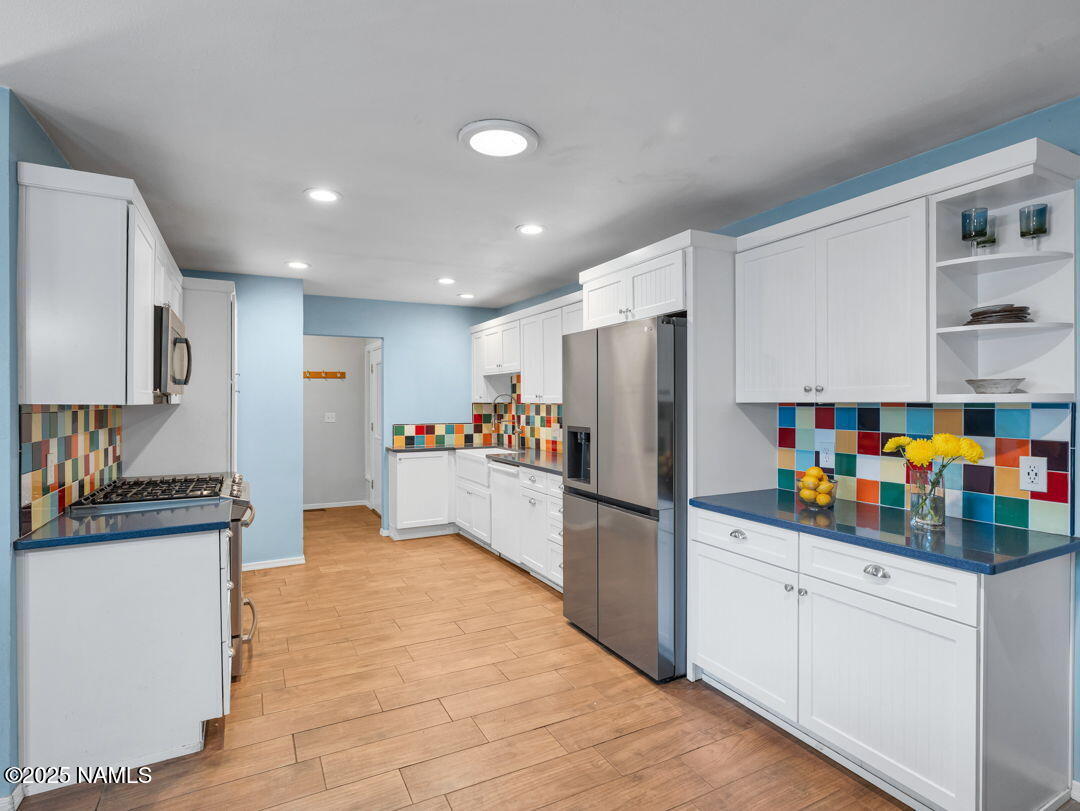 615 West Beal Road Flagstaff, AZ 86001 - Photo 8 of 37 a kitchen with stainless steel appliances a refrigerator and a stove top oven