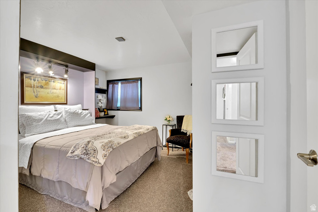 510 Spring Creek Road Providence, UT 84332 - Photo 44 of 97 Carpeted bedroom featuring a built-in headboard with integrated shelving and task lighting, a recessed window, and wall-mounted floating shelving