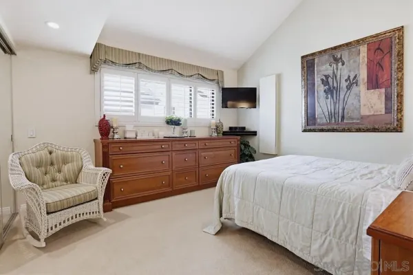 a bedroom with a bed and a couch