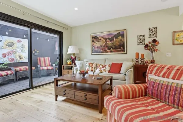 a living room with furniture and painting on the wall