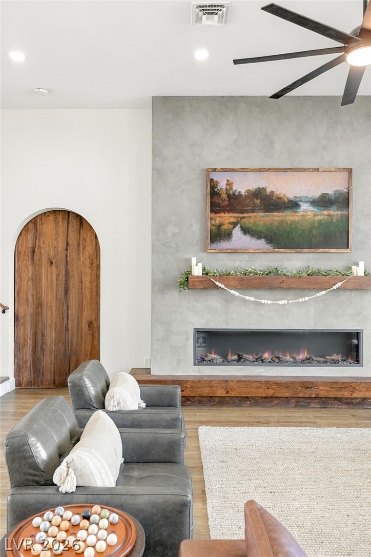 324 Wanda Road Henderson, NV 89002 - Photo 11 of 96 A modern fireplace acts as the focal point alongside an arched wooden doorway.