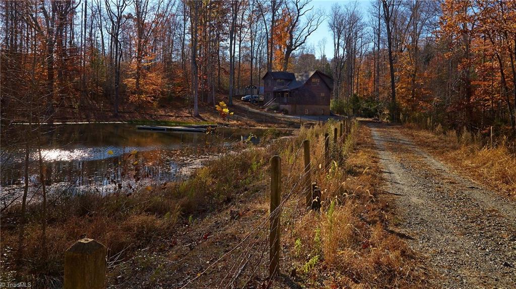 544 Neal Road Madison, NC 27025 - Photo 2 of 28 The peace and quiet of country living! This is your private driveway passing by your own stocked fishing pond!
