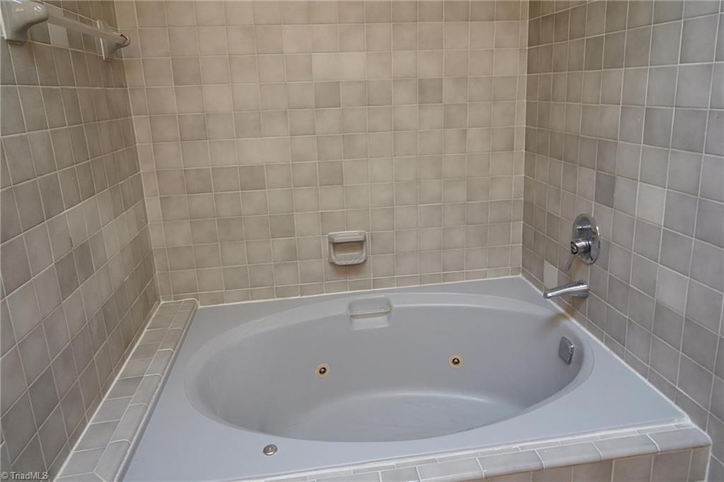 544 Neal Road Madison, NC 27025 - Photo 16 of 28 Relax and enjoy the jetted tub with tile surround in the second level bathroom. Not pictured overhead is the bright skylight!