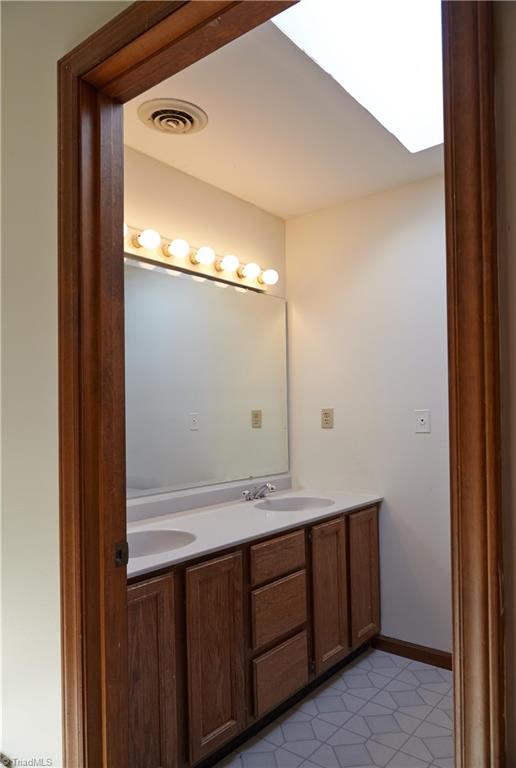 544 Neal Road Madison, NC 27025 - Photo 17 of 28 Second level bathroom with double sinks, marble counters, and a bright skylight!