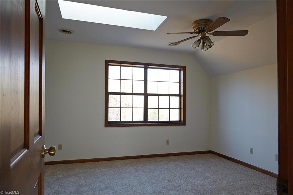 544 Neal Road Madison, NC 27025 - Photo 18 of 28 Additional second level bedroom with skylight. There is access to eave attic storage from this bedroom.