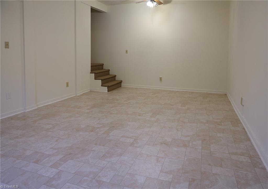 544 Neal Road Madison, NC 27025 - Photo 19 of 28 Additional den or rec room located in the finished basement. New vinyl floors. New Basement & main level heat pump in 2012.