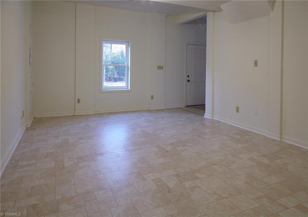 544 Neal Road Madison, NC 27025 - Photo 20 of 28 Outside basement entrance leads into large room that can be used as a den, rec room, or exercise room.