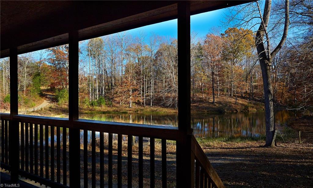 544 Neal Road Madison, NC 27025 - Photo 3 of 28 Relax on the deck and enjoy the view of your private stocked fishing pond and the surrounding nature!