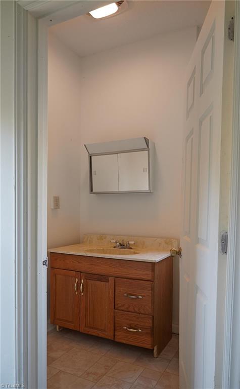 544 Neal Road Madison, NC 27025 - Photo 25 of 28 Full bathroom in finished basement. Marble counter top & new vinyl flooring.