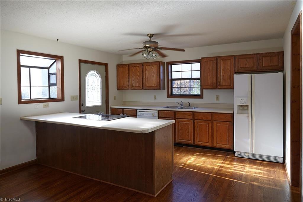 544 Neal Road Madison, NC 27025 - Photo 7 of 28 Kitchen has plenty of counter space, a window box, and there's a walk-in pantry just through the door. Beautiful hardwoods extend through the entire main level!