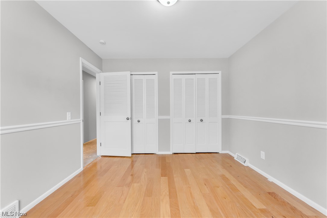 5025 Clubside Road Lyndhurst, OH 44124 - Photo 21 of 35 Unfurnished bedroom featuring multiple closets and light hardwood / wood-style floors