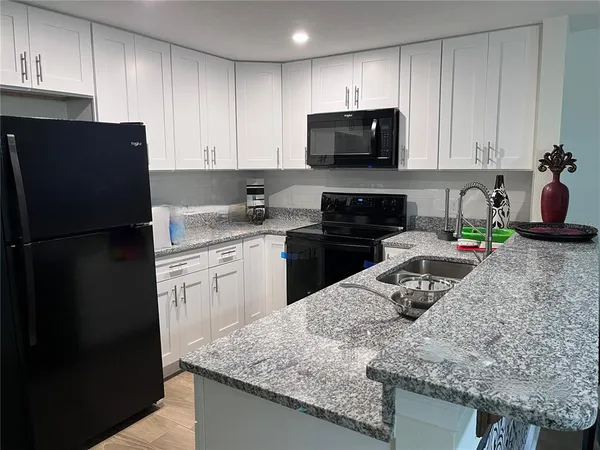 a kitchen with a sink a stove and refrigerator