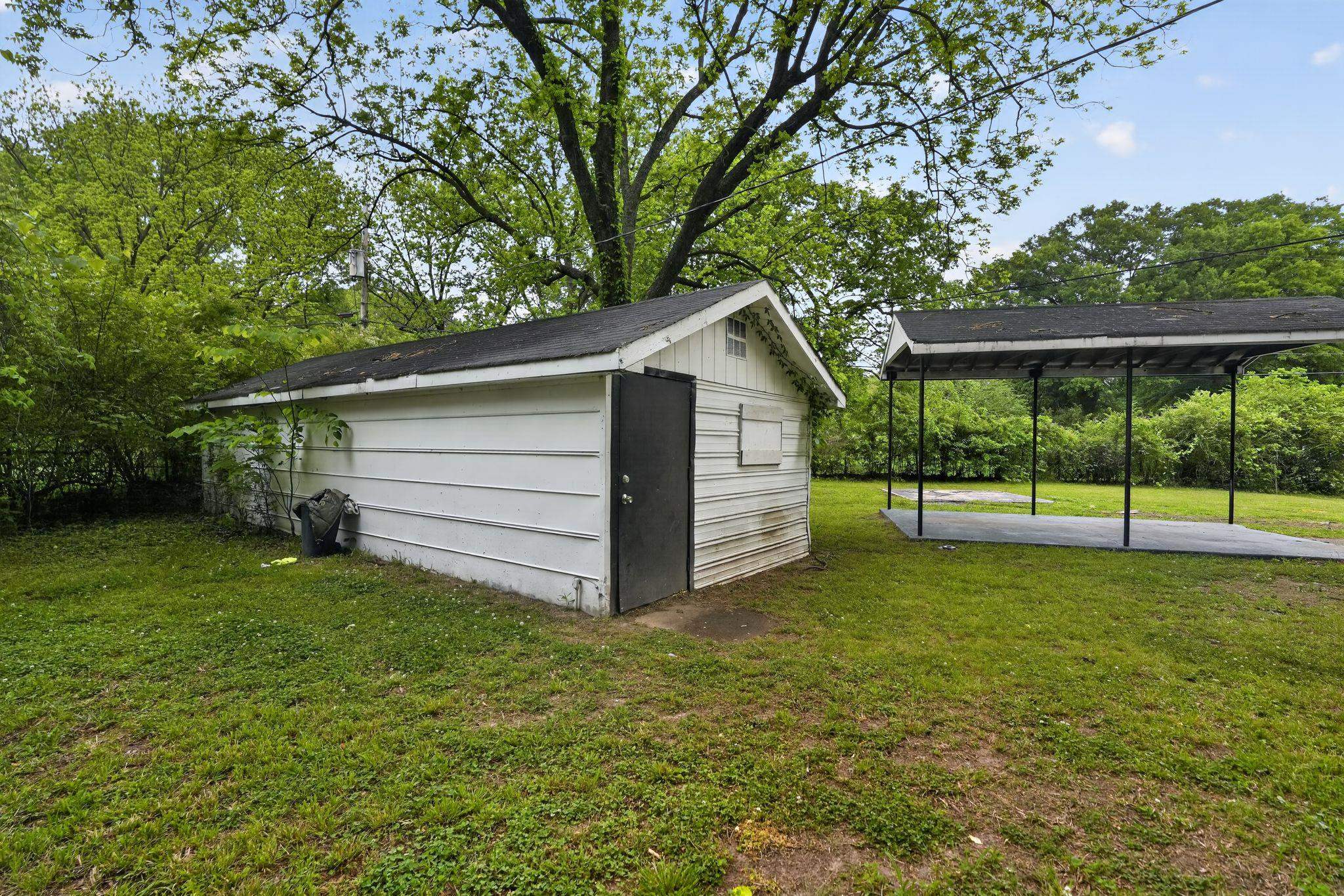 4067 Grantham Road Memphis, TN 38109 - Photo 8 of 34 a view of a house with a yard and a large tree