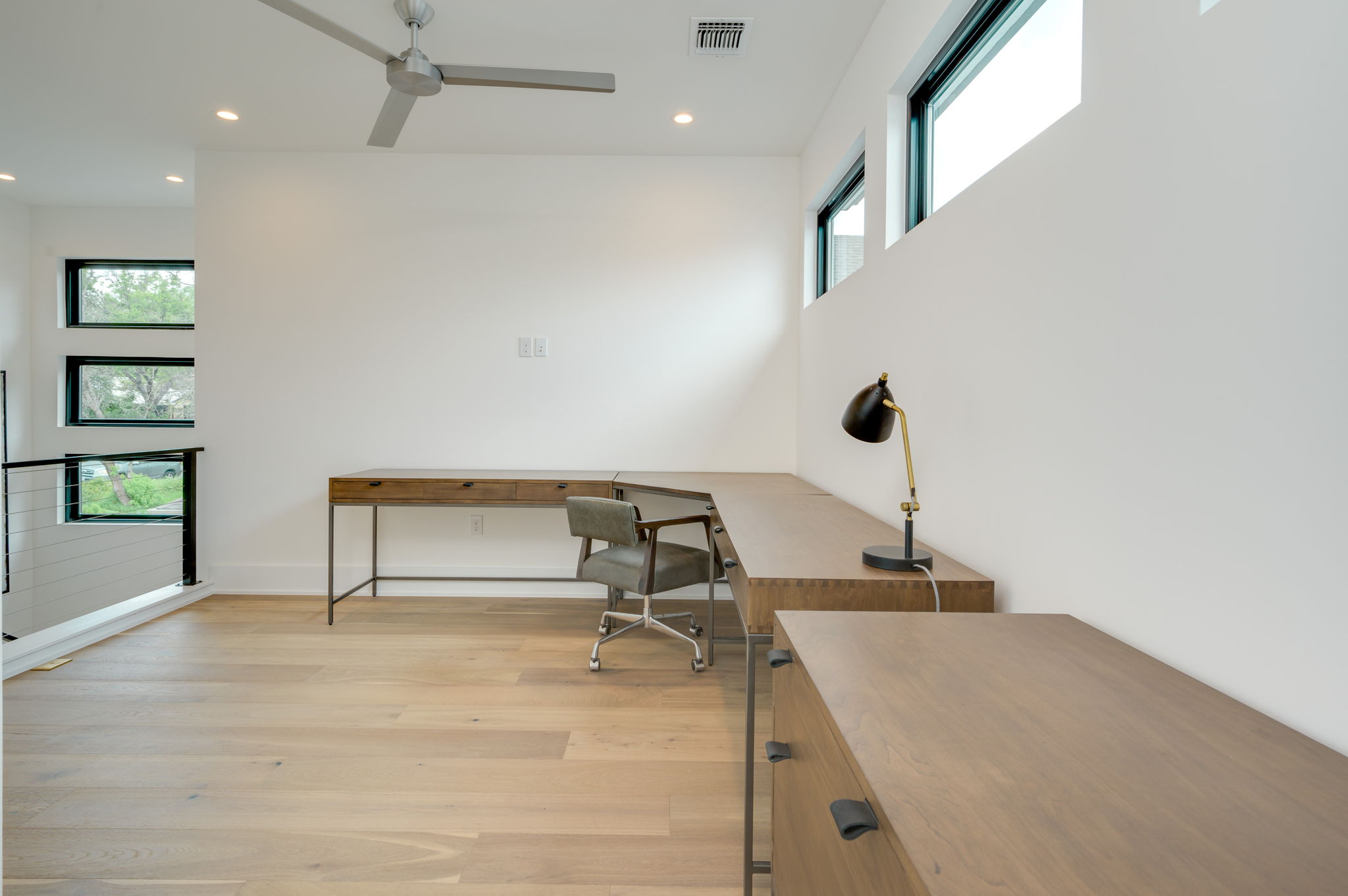 2415 McCall Road Austin, TX 78703 - Photo 32 of 40 Well-lit study with generous built-in desk space, recessed lighting, and rich hardwood flooring.